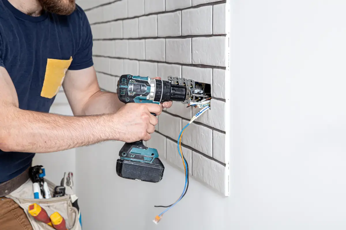 dbc-electrician-construction-worker-overalls-with-drill-installation-sockets-home-renovation-concept